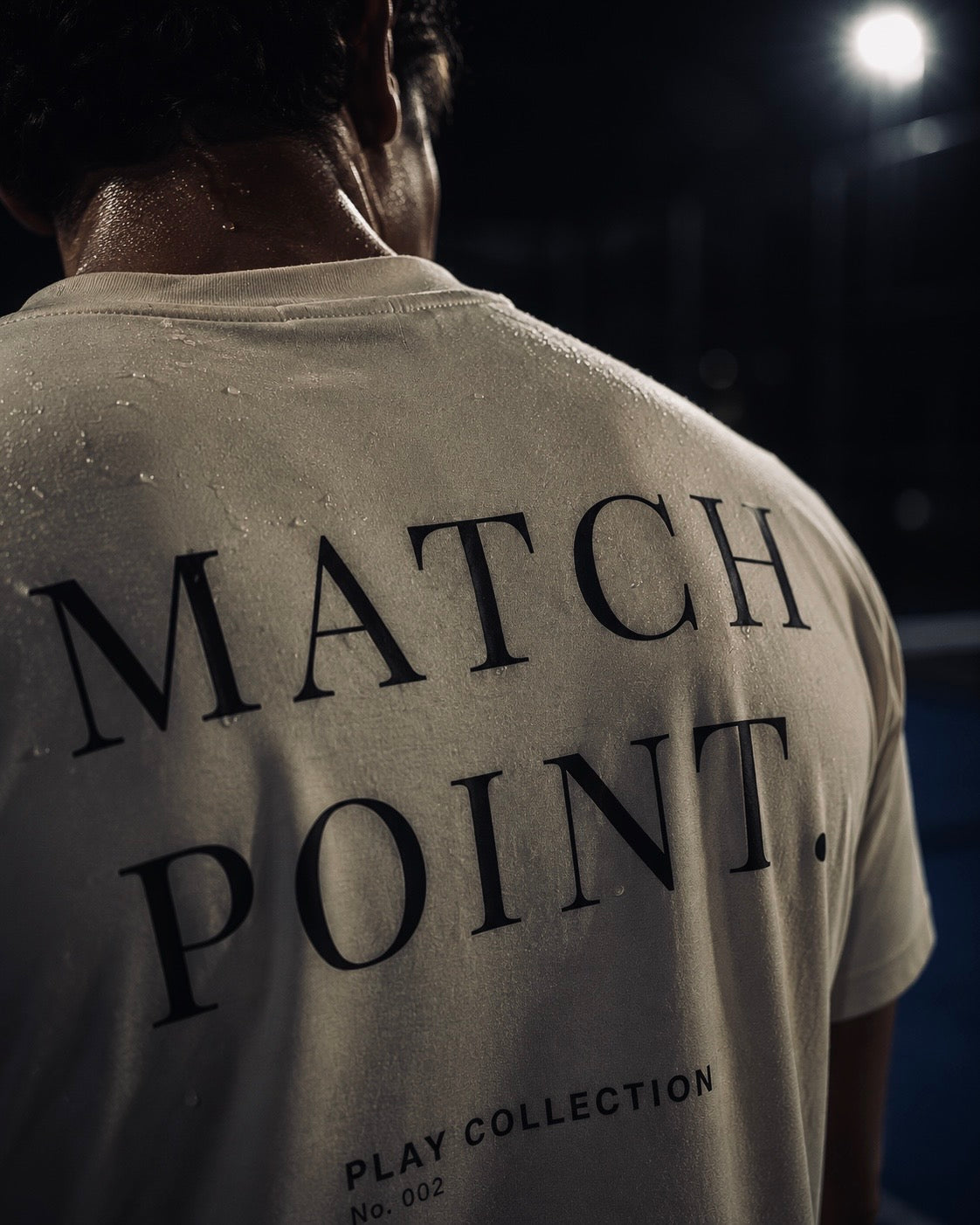 AP Club Match Point Tee (Play Collection No.002) – close-up back view of off-white t-shirt with 'MATCH POINT' graphic, British padel apparel.