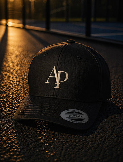 Black AP Club cap with a logo on a textured surface