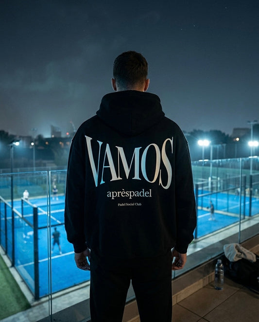Person wearing AP Club VAMOS hoodie on a padel court at night.